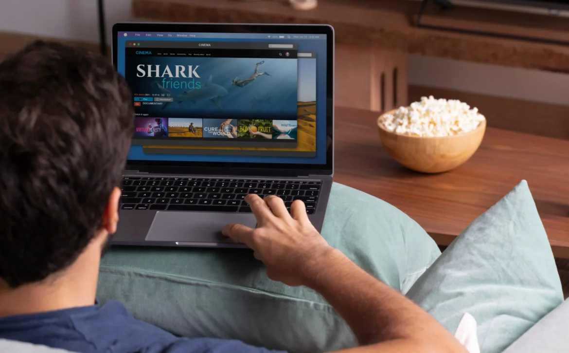 Viewer browsing an on-demand catalogue on a laptop