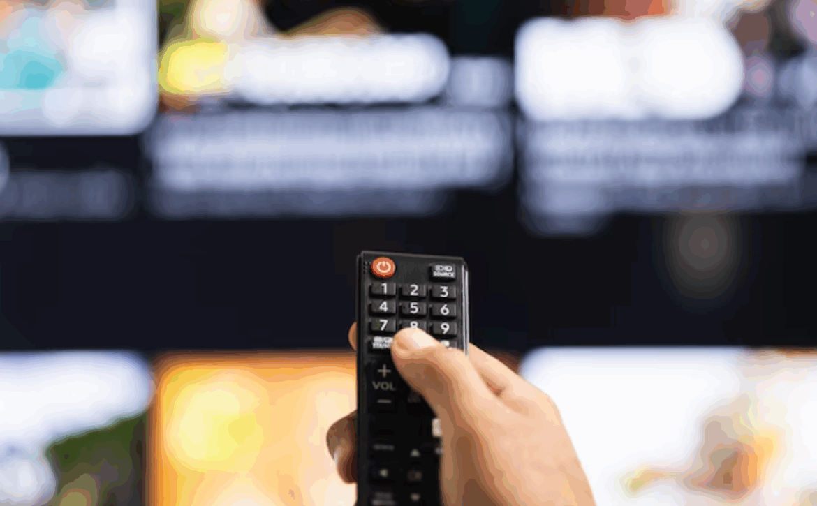 Viewer scrolling a television guide with a remote control